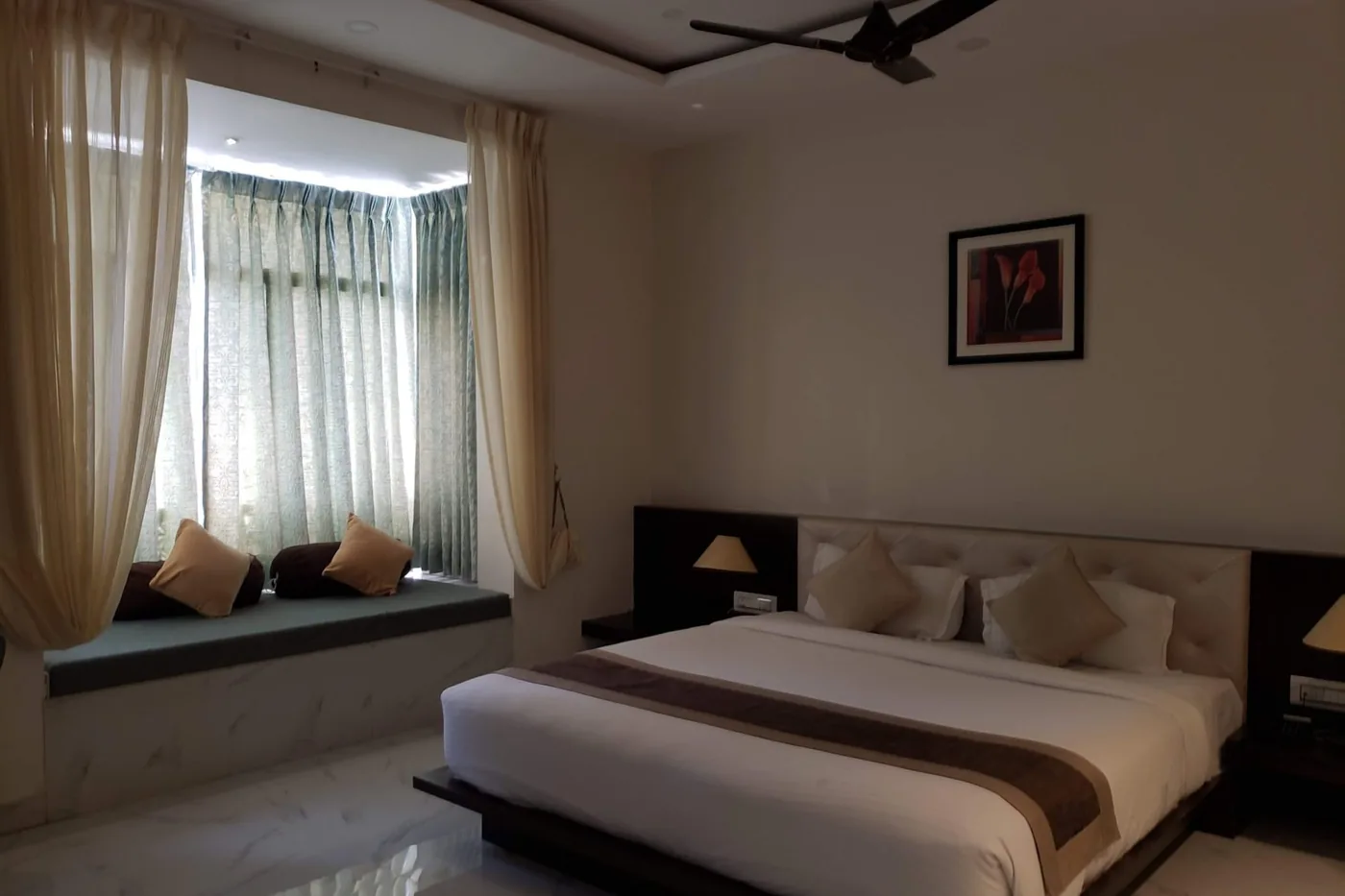 Çift kişilik otel odasında çalışma masası ve oturma köşesi